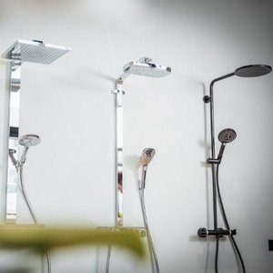 Ein elegantes Badezimmer-Setup mit zwei Duschsystemen, das eine harmonische Kombination aus Chrom und Schwarz präsentiert.