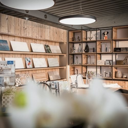 Ein modernes Innendesign mit Holzregalen, die verschiedene dekorative Objekte und Kunstwerke präsentieren.